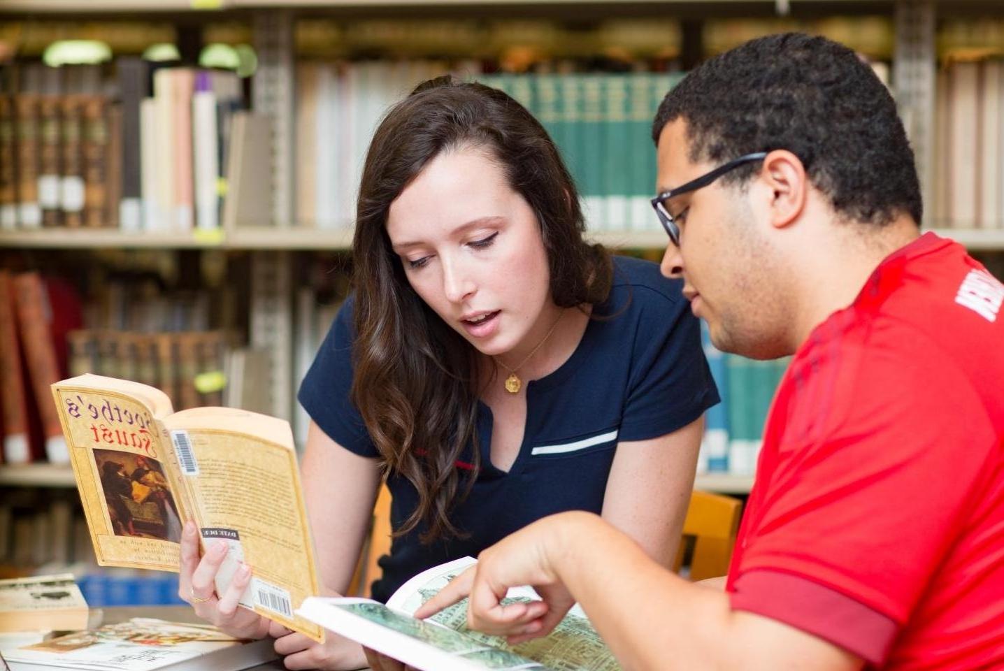 两个学生看一本书里面的地图